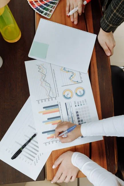 A top view of marketing strategy documents and graphs arranged on a desk, showcasing business planning.